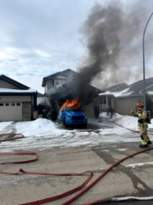 Regina Firefighters Battle Blaze as Truck Burns in Residential Driveway