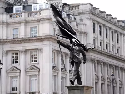 New Banksy Statue Appears in London: Man with Flag-Covered Face Draws Crowds