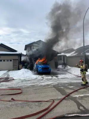 Regina Firefighters Battle Blaze as Truck Burns in Residential Driveway