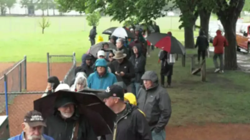 Hundreds Brave Rain for Forever Canadian Lawn Sign in Calgary