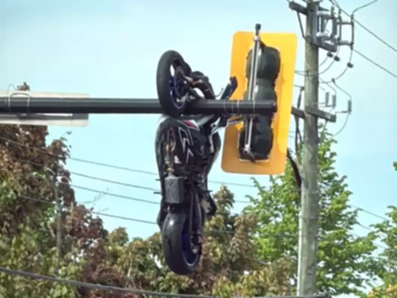 Motorcyclist Hospitalized After Crash Leaves Bike Hanging from Traffic Lights