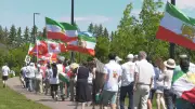 Dozens Walk in Hawrelak Park Marking Lion and Sun Day for Iran