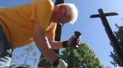 Master carver restoring historic totem pole outside Royal BC Museum in Victoria